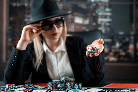 Woman player hold poker chips on the table with card in a casino. Jackpotの写真素材