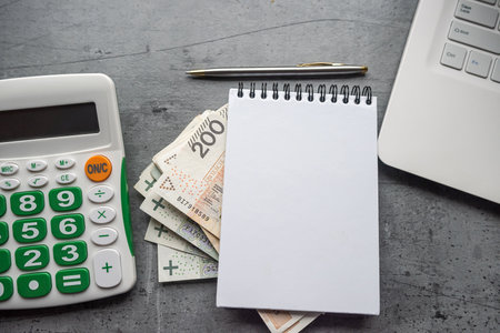 Finance background pln zloty money with empty notepad calculator and laptop, Saving conceptの写真素材