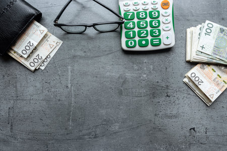 Financial saving accounting pln zloty in wallet and calculator on desk. Paymentの写真素材