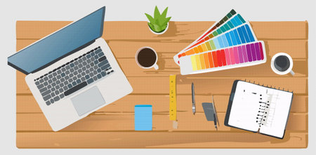 An artistic depiction in pixel art style showcasing a workspace desk that features a laptop, several books, paint brushes, and a small fan for comfortのイラスト素材