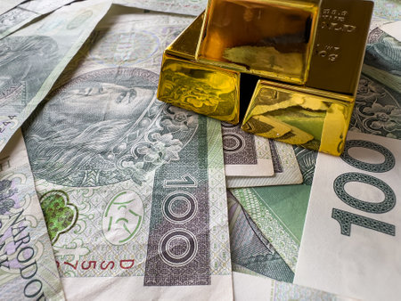 Gold bars with polish paper money or banknotes. Money and financial conceptの写真素材