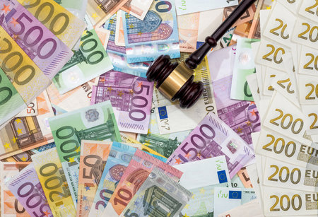 auction hammer on eu euro money banknotes as finance background. jugde gavel vs moneyの写真素材