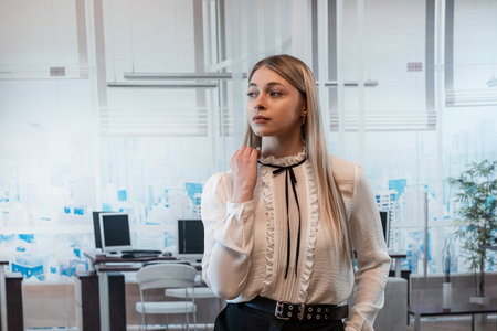 Blonde business woman in a white blouse in office building. Fashion portrait, lifestyleの写真素材
