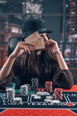 Woman holding ace playing cards in her hands at casino poker room. Card game winningの写真素材