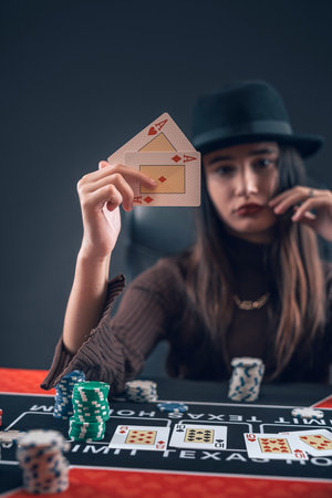 Woman holding ace playing cards in her hands at casino poker room. Card game winningの写真素材
