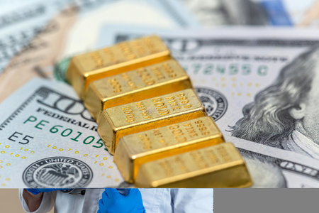 gold bars lie on paper us dollars bills, investment business currency conceptの写真素材