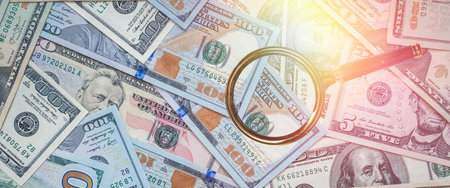 magnifier glass with US USD paper dollar bills. Economy and finance conceptの写真素材
