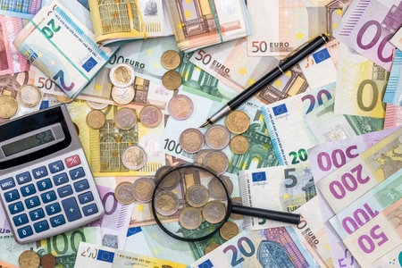 hand magnifier over EU euro paper bills. Economy or debt analysis conceptの写真素材