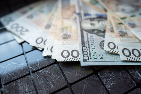 200 pln Polish zloty vs 100 US dollar banknotes as exchange rates. Spilled money. Financial conceptの写真素材
