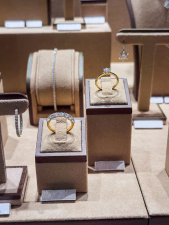 variety of golden rings, bracelets necklaces jewelry with diamant in store window. Shopping luxury conceptの写真素材