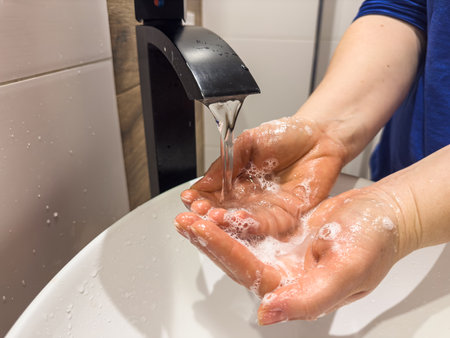 woman washing thoroughly hands with soap in toilet cleanliness and prevent germs coronavirusの写真素材