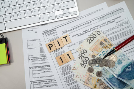 Declaration individual income PIT11 tax form pen and polish zloty money on desk