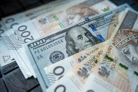 200 pln Polish zloty vs 100 US dollar banknotes as exchange rates. Spilled money. Financial conceptの写真素材