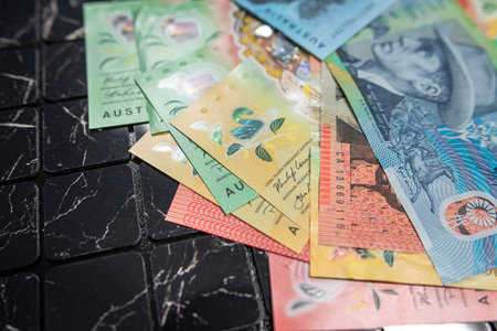 many different new polymer of different denominations Australian dollars banknotes on dark background.の写真素材