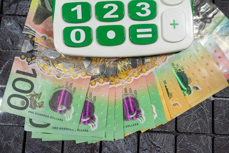 AUD Australian money bills with calculator on black background. Financial conceptの写真素材