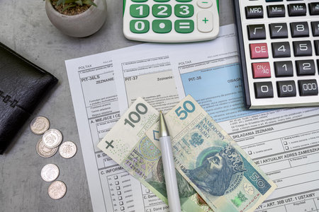 Declaration of polish tax form PIT-37 and PIT-38 with pln zloty pen and calculator on accountant table. Tax time. Accounting conceptの写真素材