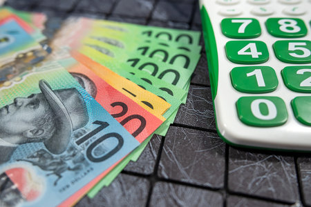AUD Australian money bills with calculator on black background. Financial conceptの写真素材