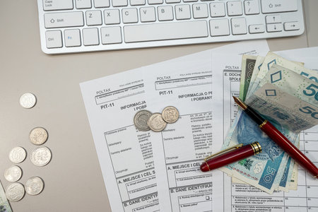 Declaration individual income PIT11 tax form pen and polish zloty money on desk