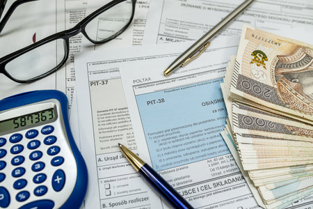 PIT-38 PIT 37 empty form, annual tax return to the tax office, zloty money calculator pen clock and glasses aの写真素材