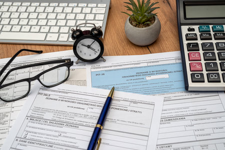 Polish PIT 11 37 38 tax form prepared to be filled with pen calculator glasses on desk aの写真素材