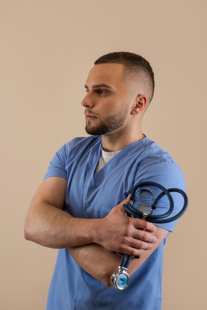 Portrait of caucasian young male doctor in blue uniform with stethoscope isolated. Medical conceptの写真素材