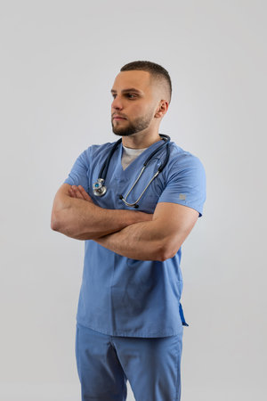 Young caucasian male doctor or nurse in blue uniform and stethoscope isolated. Medical staffの写真素材