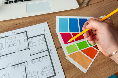 Drawings, architectural drawings of the modern house with color swatches on table. Construction plan...