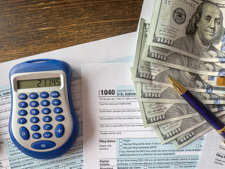 Financial individual tax form return 1040 pen calculator dollar cash on office desk. Taxation conceptの写真素材