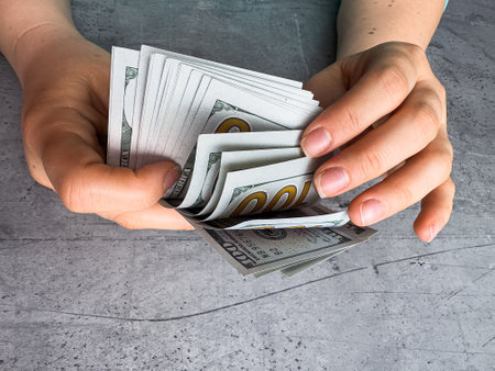 woman count 100 dollar bill or cash with money laundering.  Fraud, accounting and investment conceptの写真素材