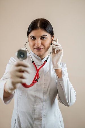 Portrait of caucasian woman doctor wearing white coat uniform with a stethoscope isolated.の写真素材