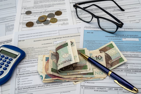 PIT 36 37 38 11 form on accountant with pln zloty money money bills calculator. CIT and VAT tax formsの写真素材