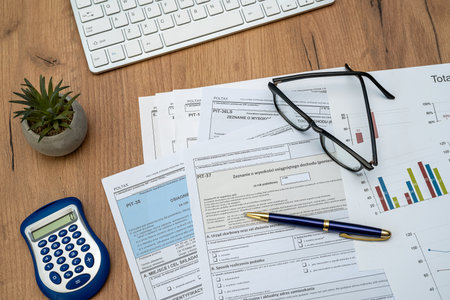 Polish individual income tax form PIT with pen calculator glasses on desk. Workplace Polish tax formsの写真素材