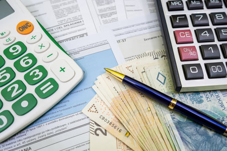 Declaration of polish tax form PIT-37 and PIT-38 with pln zloty pen and calculator on accountant table. Tax time. Accounting conceptの写真素材