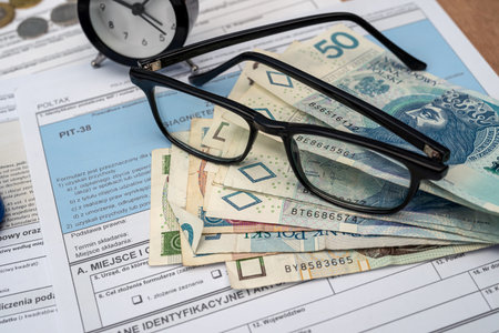 Pln polish money zloty glasses calculator pen on poland pit form. Taxation a business conceptの写真素材