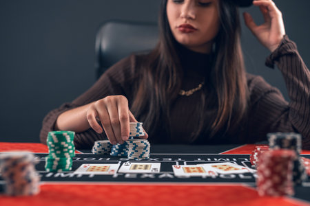 Young pretty caucasian female player in a casino makes bets for big winner. Gamblinf concept,...