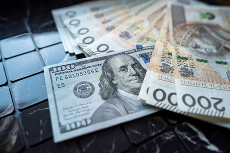 200 pln Polish zloty vs 100 US dollar banknotes as exchange rates. Spilled money. Financial concept