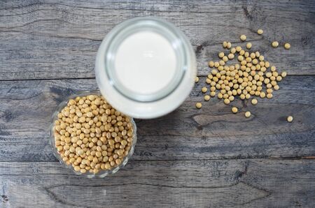 Bottle of soy milk, bowl with soy beansの写真素材
