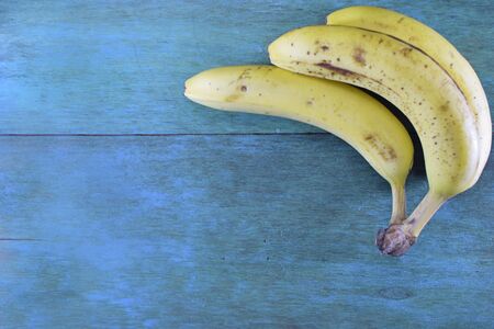 Bananas on a blue wooden tableの写真素材