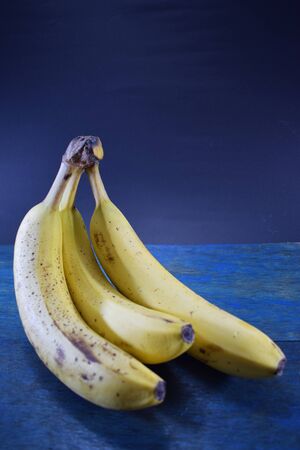 Bunch of banana on wooden table and black backgroundの写真素材