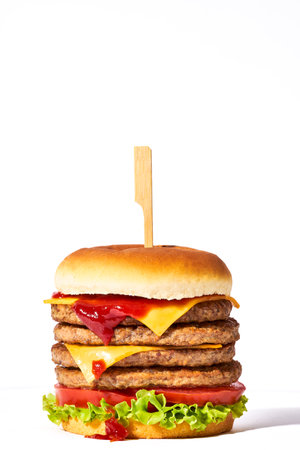 quadruple meat burger isolated on white backgroundの写真素材