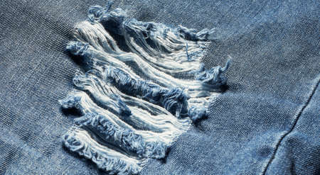 close up view of ripped denim blue jean isolatedの写真素材