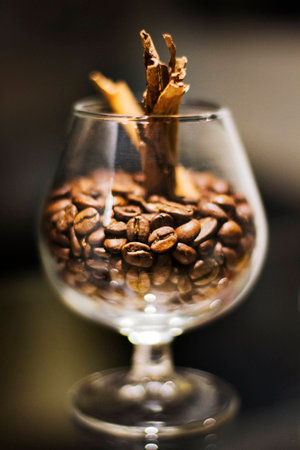 Cup whith roasted brown bean of coffee.
