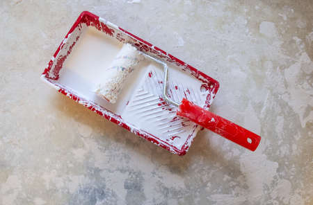Roller and tray of red color for painting wallsの写真素材