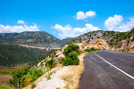 The road to the picturesque green mountainsの写真素材