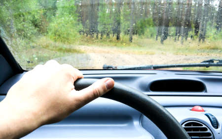 Man's hand on the wheel of a carの写真素材