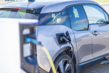 Electric car charging at a station in Europe