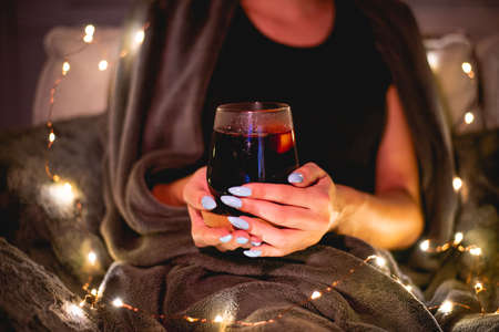 Girl holding glass of mulled wineの写真素材