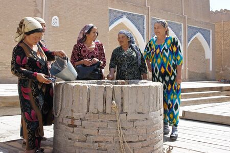Khiva, Uzbekistan, May 2012: Five old Usbek women standing around an on wellのeditorial素材