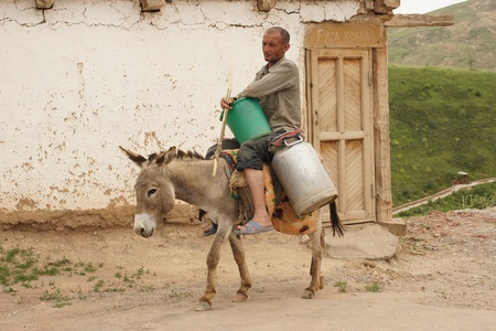 Hissar Mountains, Uzbekistan, May 2012: Man riding donkeyのeditorial素材