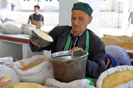 Samarkand, Uzbekistan, may 2012:  Man trading on a food market.のeditorial素材